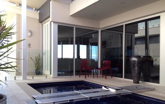 Clean glass doors around a courtyard pool at an Adelaide home